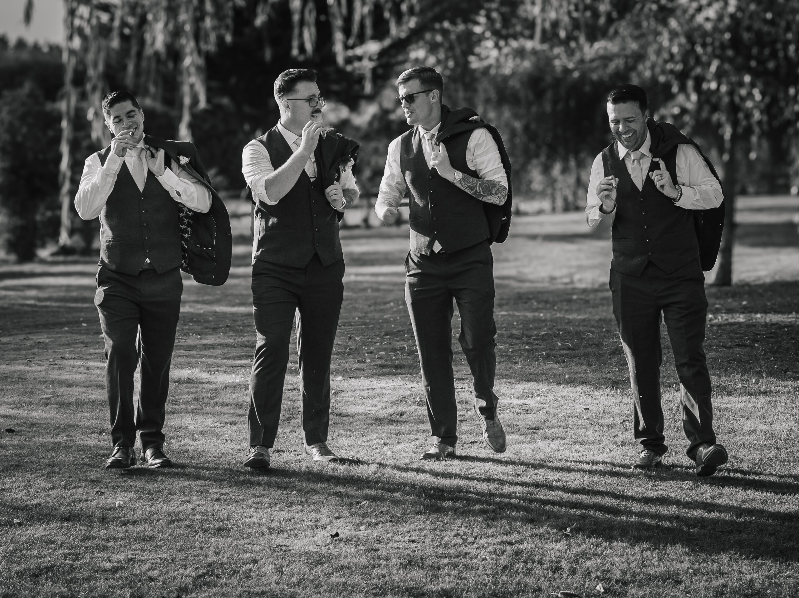 blossom-tree-wedding groomsman taking a walk celebrating with cigars