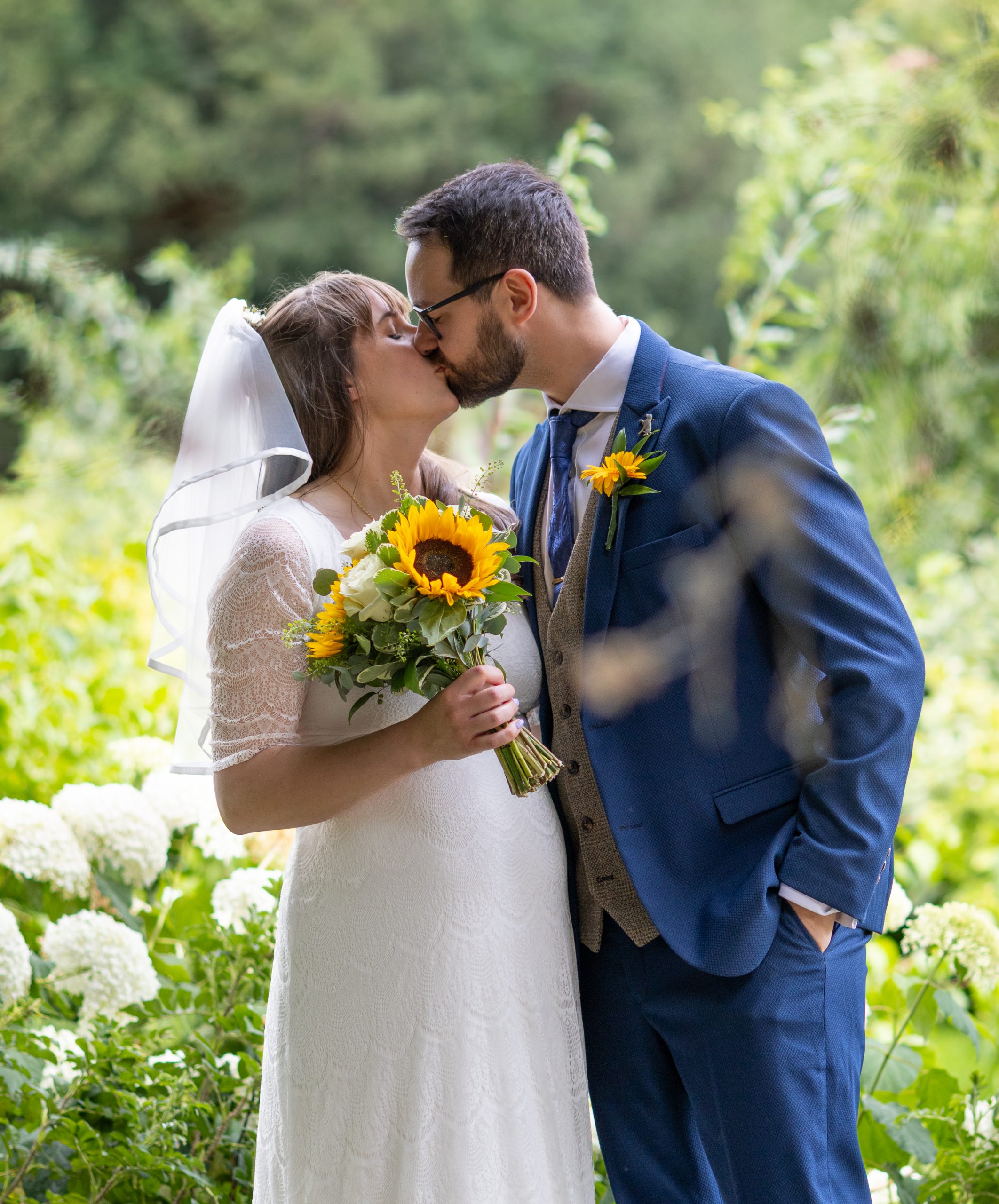blossom-tree-wedding married couple sharing a kiss in Abbey Gardens